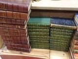 many books stacked on top of each other on a table