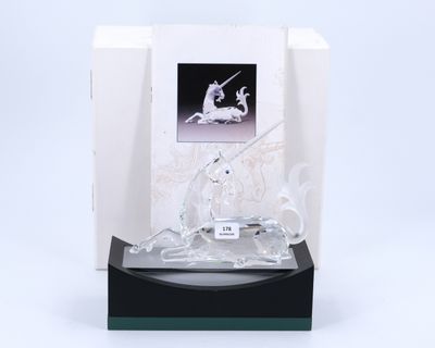 crystal figurine of a unicorn and a horse on a black base