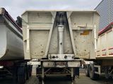 two boats sitting on the back of a truck