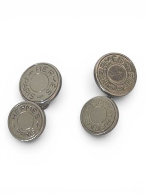 three coins sitting on top of each other on top of a white surface