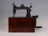 an old sewing machine sitting on top of a wooden box