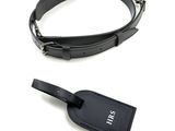 a black luggage tag and a black belt on a white background
