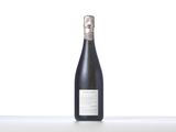 a bottle of wine sitting on top of a white table