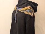 black hoodie with gold and blue wings on a mannequin head