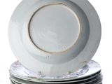 several plates stacked on top of each other on a white surface