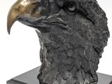 statue of an eagle head on a pedestal with a white background