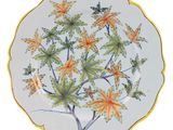 a plate with a yellow and green leaf design on it