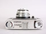 a silver camera that is sitting on a white surface