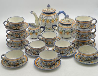 a lot of cups and saucers that are sitting on a table