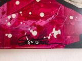painting of a woman ' s face on a pink background with white dots