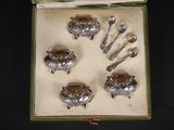an assortment of silverware in a box on a black surface
