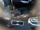 a view of the inside of a car through a chain link fence