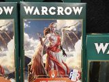 three boxes of warcraw cards are on a table