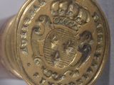 a close up of a gold colored object with a crown on it