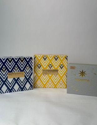 three boxes with different designs on them sitting next to each other