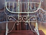 a metal cradle that is sitting on a wooden stand