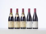 four bottles of wine are lined up on a table