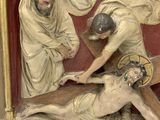 a statue of jesus on the cross being nailed to the cross