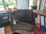 a computer desk with a keyboard, mouse, and monitor on it