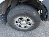 a white truck with a flat tire on the street
