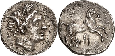 a silver coin with an image of a horse and a man on it
