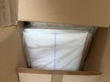 a cardboard box that has some white sheets in it