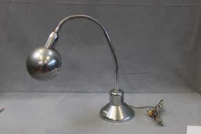 a silver lamp that is on a table