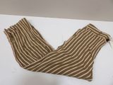 brown and white striped pants laying on a white surface