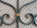 a metal gate that has a padlock on it