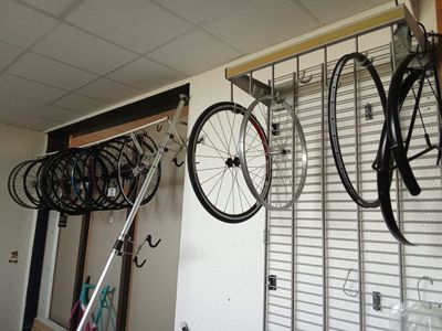 many bikes hanging on the wall in the garage