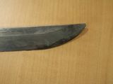 a knife that is sitting on a wooden table