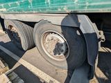 a truck that is parked in a lot with a lot of pallets