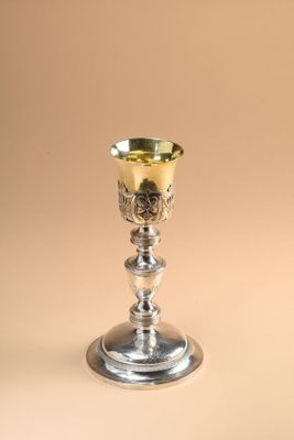 silver plated goblet with a floral design on the rim