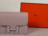 the hermes bag is sitting on the table next to the orange box