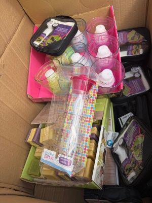 a cardboard box filled with baby products and other items
