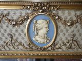 a gold frame with a picture of a woman on it