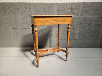 an old wooden table with a drawer on top of it