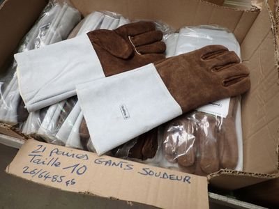 a cardboard box filled with gloves and gloves for sale