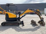 an image of a small excavator parked in a parking lot