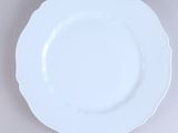 an overhead view of a white plate on a gray surface