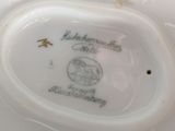 a white plate with a picture of a horse and a bird on it