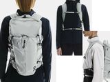 a woman with a backpack that is wearing a hoodie