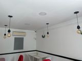 three red chairs and a table in a small room