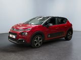 a red citrole is parked in a white room