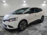 a white car parked in a garage with a checkered floor