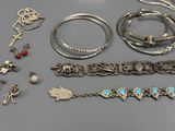 many different bracelets and rings that are on the table