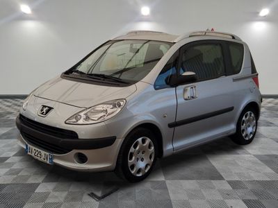 a picture of a small silver car parked in a garage