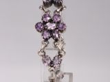 an image of a purple and silver ring on a white pedestal