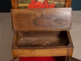 an old wooden box with a painting on it