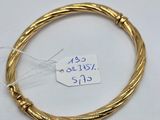 a close up of a gold bracelet with a price tag on it